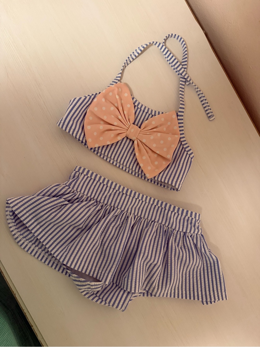 Ruffle Butts Blue and White Striped Skirted Swim Set with Peach Bow